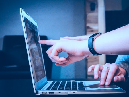 Image of people discussing something on the laptop screen