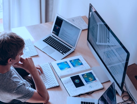 image of a man looking at the computer screens with CMS dashboard displayed